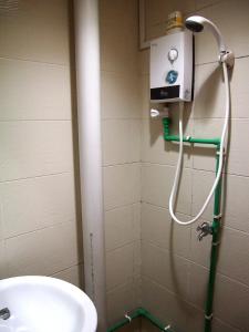 a shower in a bathroom with a sink at Snooze Inn @Dunlop Street in Singapore +22 photos