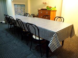 a table with chairs and a checkered table cloth on it at Snooze Inn @Dunlop Street in Singapore