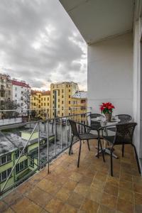a balcony with chairs and a table with a view at Stylish Apartments close to Eden Garden in Prague