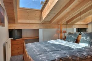 a small bedroom with a bed and a window at Olympia 443 in Verbier