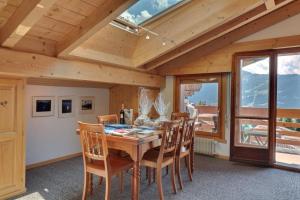 a dining room with a wooden table and chairs at Olympia 443 in Verbier