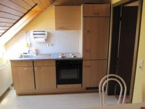 a small kitchen with a sink and a stove at Fewo am Ith in Salzhemmendorf