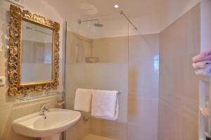 a bathroom with a sink and a shower with a mirror at La Bastide des Pins in Vence