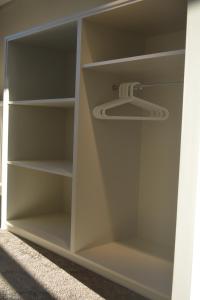 a white closet with shelves at Appartroom Hasselt in Hasselt