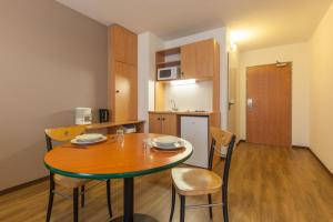 a kitchen and dining room with a table and chairs at City Residence Access Strasbourg in Strasbourg