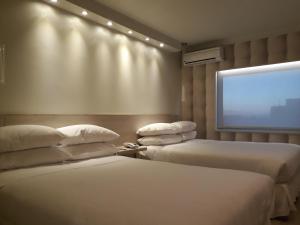 Katil atau katil-katil dalam bilik di Hotel Las Terrazas Business