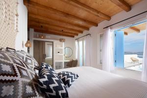 a bedroom with a bed and a large window at Litore Suite in Pollonia