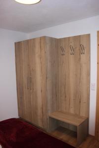 a large wooden cabinet in a room with a bed at Hinterschwarzenau in Auffach
