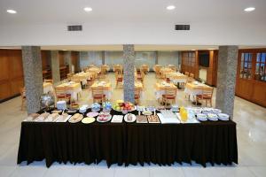 a table with plates of food on it in a restaurant at Hotel Riogrande in Santa Fe