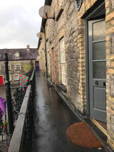 a wet street with a door and a building at Boutique Apartment Ballina Town Centre in Ballina