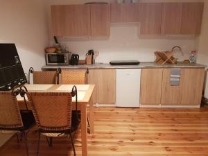 a kitchen with a table and chairs and a table and a counter at 42-200 Hostel in Częstochowa