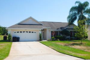 a house with a driveway and a palm tree at Lake View Villas in Kissimmee
