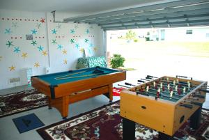 two ping pong tables in a living room with at Lake View Villas in Kissimmee