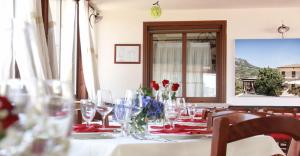a table with wine glasses and flowers on it at La Vista del Taburno in Montesarchio