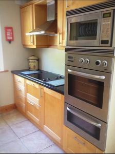a kitchen with a stove and a microwave at Earlscourt in Glenbeigh