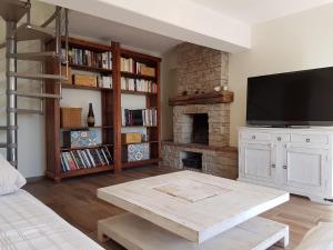a living room with a table and a fireplace at Villa Grasse Avec Spa in Grasse