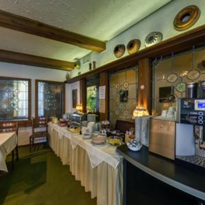 a large kitchen with a long line of tables at Hotel Gasthof Traube in Kernen