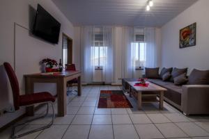 a living room with a couch and a table at Ferienwohnung Scheid in Lahr