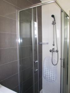 a shower with a glass door in a bathroom at Belém Cozy Bedroom in Lisbon