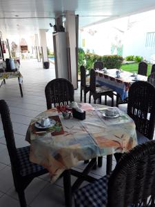a table and chairs in a restaurant with a table at Pousada Venezia in Fortaleza