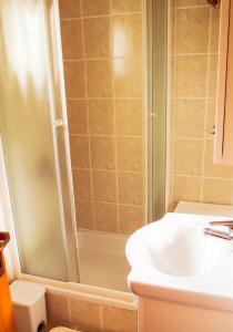 a bathroom with a shower and a sink at Adria Arba Apartments in Rab +27 photos