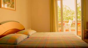 a bed with two pillows in a bedroom at Adria Arba Apartments in Rab