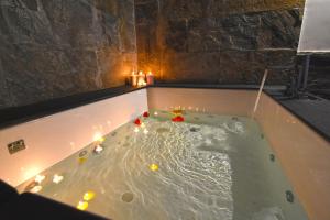a bath tub with candles in it with candles in it at Corte Capomazza Appartamenti in Naples +178 photos