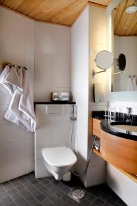 a bathroom with a toilet and a sink at Break Sokos Hotel Vuokatti in Vuokatti