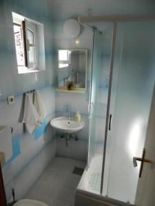 a bathroom with a shower and a sink and a toilet at Ema in Brela +20 photos