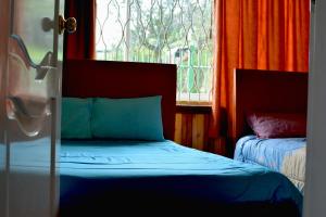 Postel nebo postele na pokoji v ubytování Hostal Mirador de Otavalo