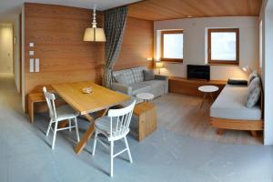 a living room with a table and a couch at Apartments Frieda in Valdaora