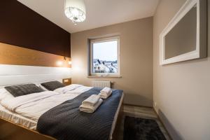 Posteľ alebo postele v izbe v ubytovaní APARTAMENTY GORZÓW WLKP.