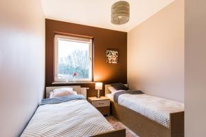 Posteľ alebo postele v izbe v ubytovaní APARTAMENTY GORZÓW WLKP.