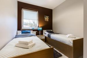 Posteľ alebo postele v izbe v ubytovaní APARTAMENTY GORZÓW WLKP.