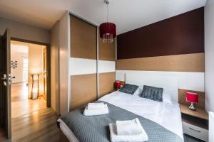Posteľ alebo postele v izbe v ubytovaní APARTAMENTY GORZÓW WLKP.