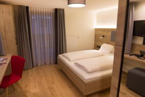 Łóżko lub łóżka w pokoju w obiekcie Hotel Rosner