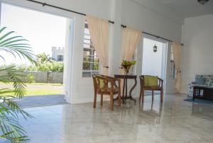 a dining room with a table and two chairs at Castles Apartments in Castries