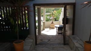 an open door to a patio with a table at Pousada Passagem dos Papagaios in Cabo Frio