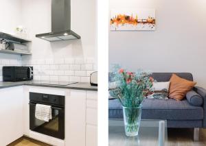 a kitchen and a living room with a couch at Beautiful City Centre Apartment - Holyrood Park in Edinburgh