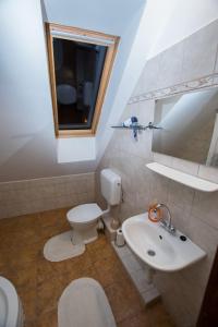 a bathroom with a toilet and a sink at Paulay Borház és Vendégház in Tokaj