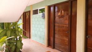 a wooden door in a house with a plant at Hotel Marina San Blas in San Blas +62 photos