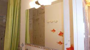 a bathroom mirror with fish decals on the wall at le Vercors en toute simplicite in Autrans +19 photos