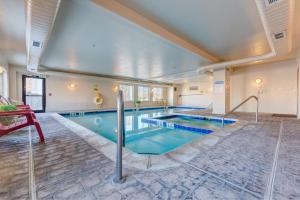 a large indoor pool with blue water in a building at Grand River Hotel in Parachute