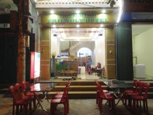 a restaurant with tables and chairs in front of a store at ninh binh friendly hotel in Ninh Binh