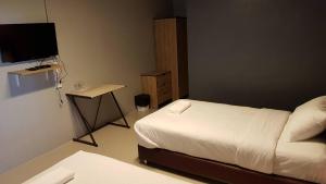 Postel nebo postele na pokoji v ubytování Baan Sang Chan 3
