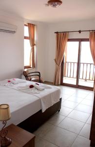 Säng eller sängar i ett rum på Veranda Hotel Bozburun
