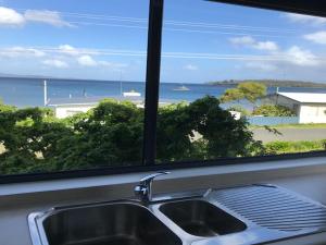 a kitchen sink with a view of the ocean at Rock Lobster in Southport