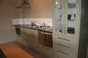 a kitchen with a sink and a stove at Leigh Apartments in Leigh