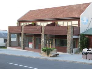 a building on the side of a street at Leigh Apartments in Leigh