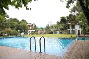 a swimming pool with two metal handles in the water at Bidaisari Resort in Kampong Sum Sum